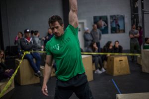 An Invictus athlete doing a dumbbell snatch in the CrossFit Open 17.1 workout.