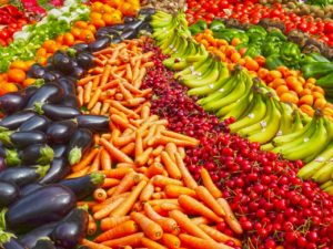 Colorful array of fruits and vegetables laid out on display.
