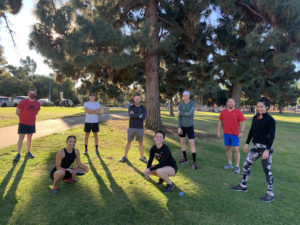 Invictus Run Club members gather in the park before a workout.