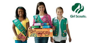 Girl Scouts with cookies for sale.